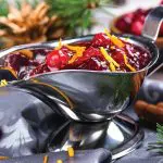 Cranberry sauce in a stainless steel sauce pan on festive christmas background