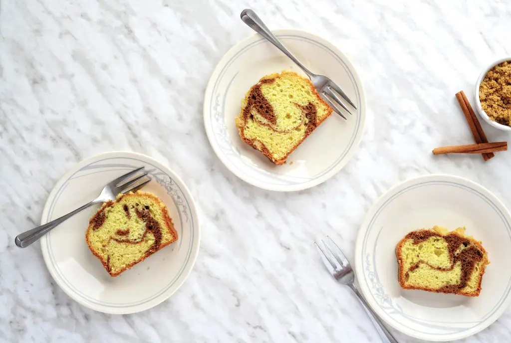 high angle view cinnamon swirl cake with plates and forks