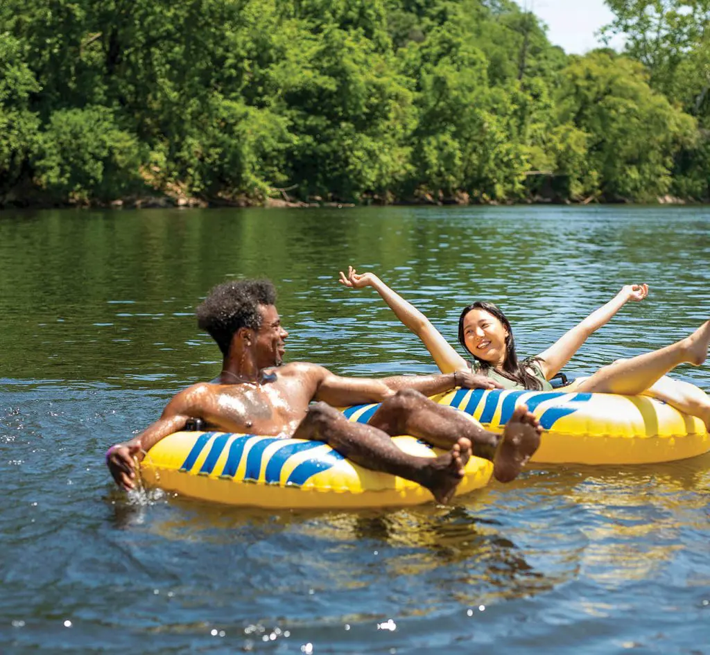 kids in yellow tubes floating in the river