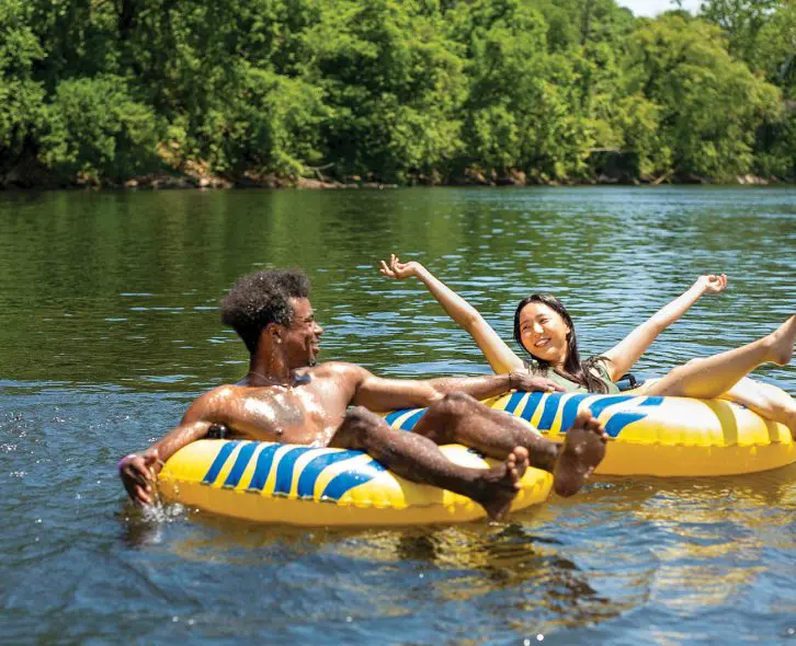 kids in yellow tubes floating in the river