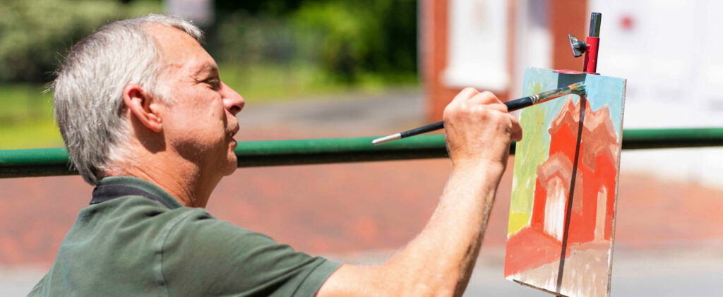 artist Chris Jones paints the fire station no. 2 building in lynchburg va