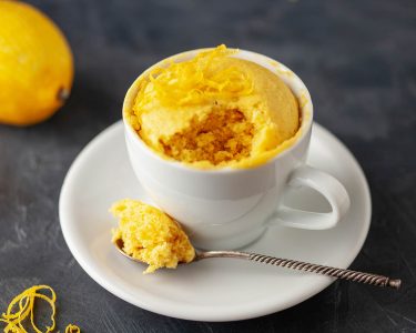 Lemon cupcake in a white mug. Easy homemade dessert. Mug cake
