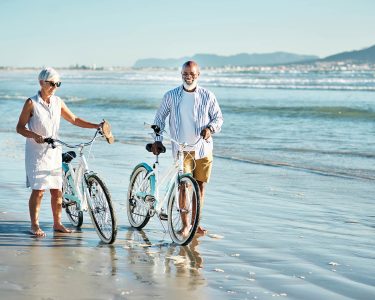 Shot of a senior couple riding their bicycles at the beach