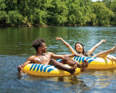 kids in yellow tubes floating in the river