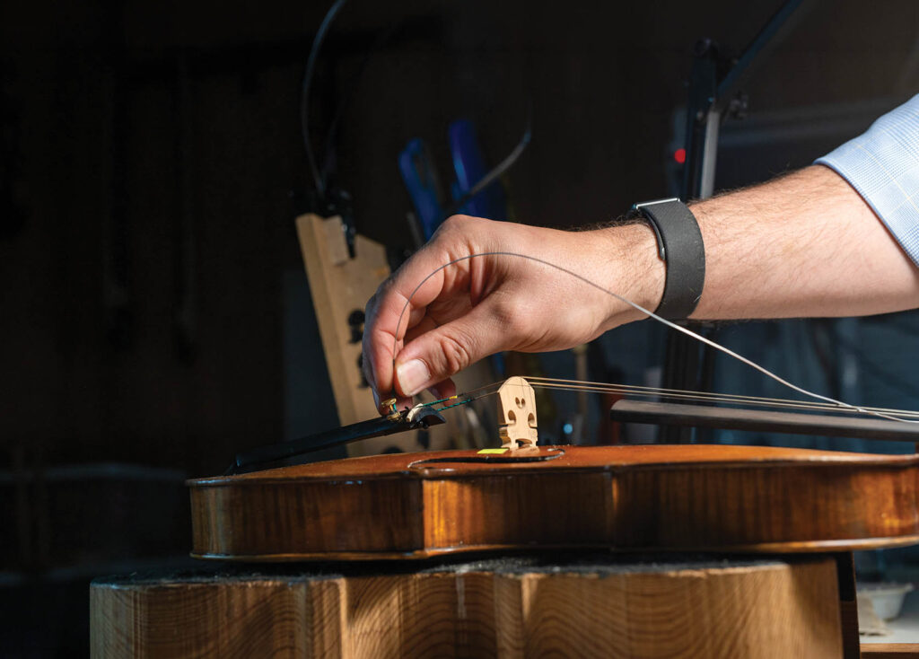 man fixing a violin