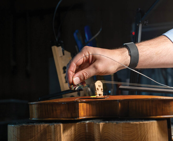 man fixing a violin